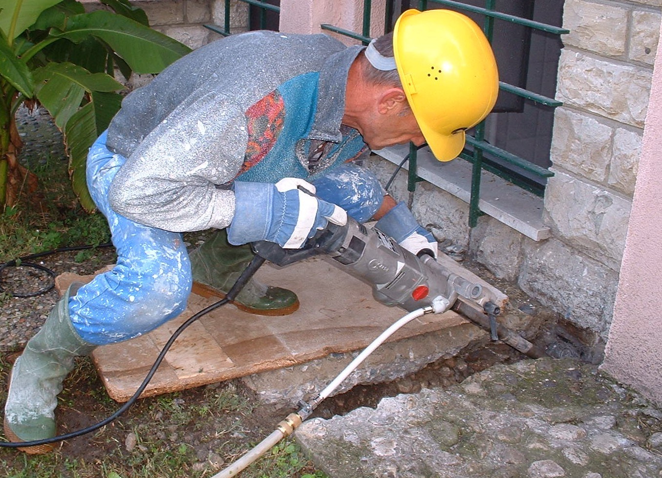 Illustrative photograph of handheld core drilling into an exterior masonry wall